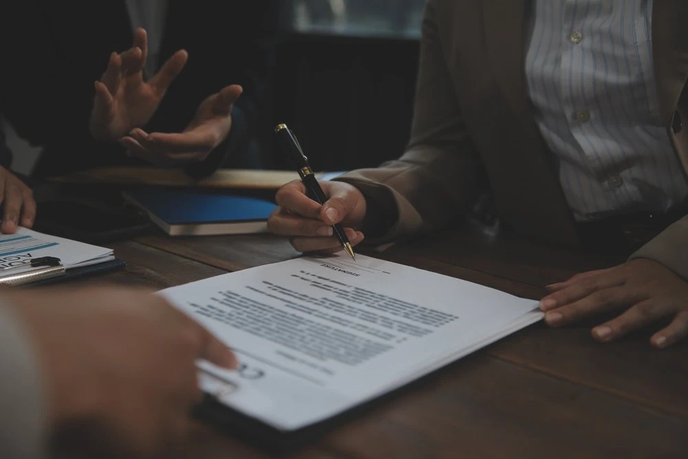 Group of people pour over legal documents.