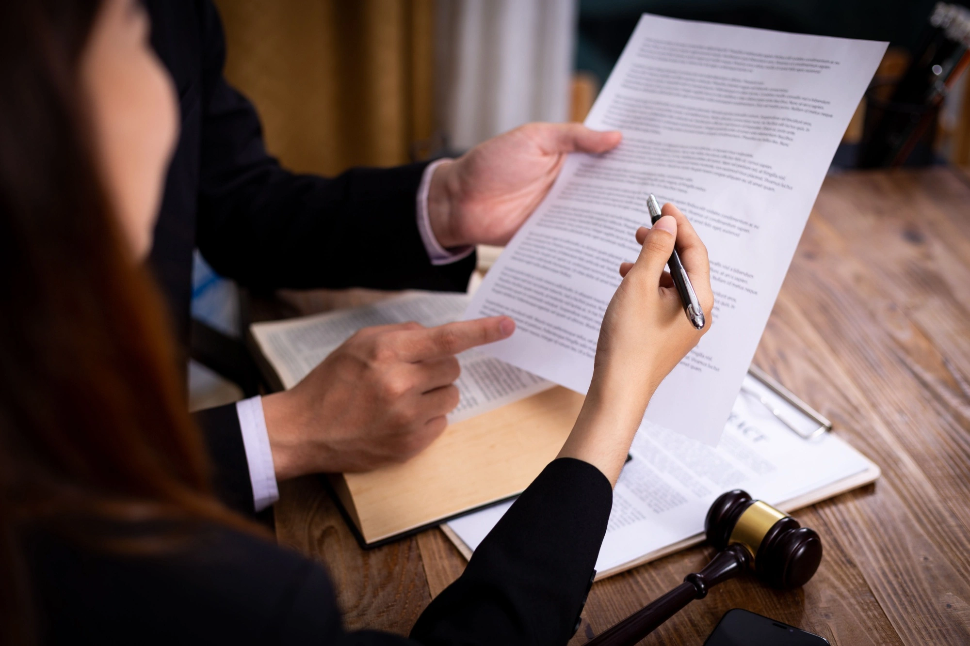 Legal malpractice mediator going over an agreement with a client