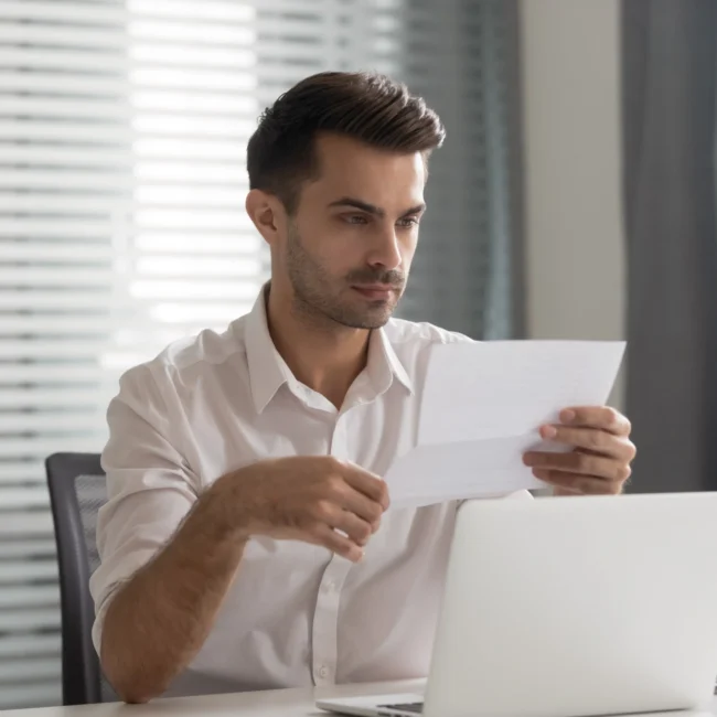 Man looking at a detailed attorney invoice