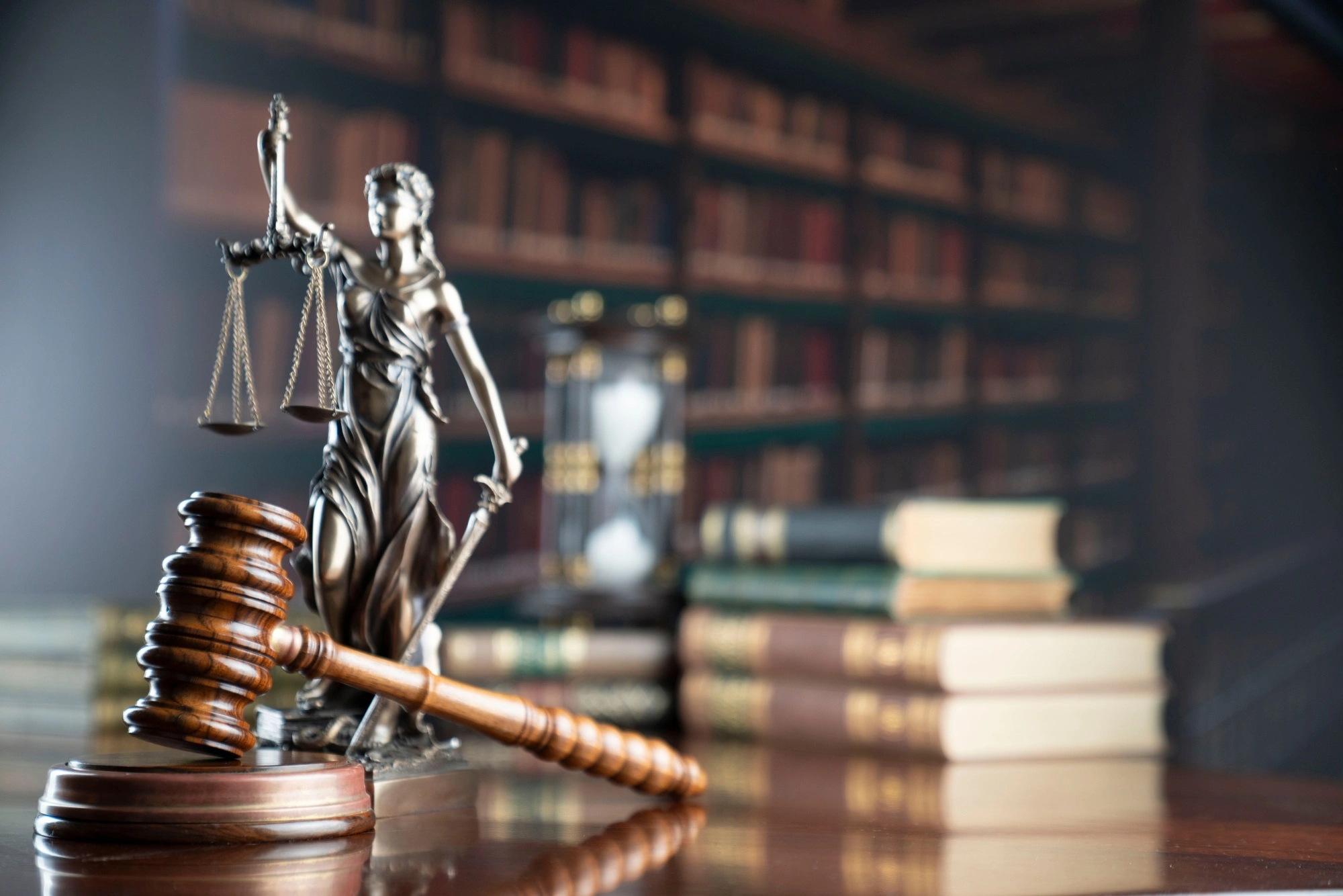 Gavel on a bench in front of a legal statue