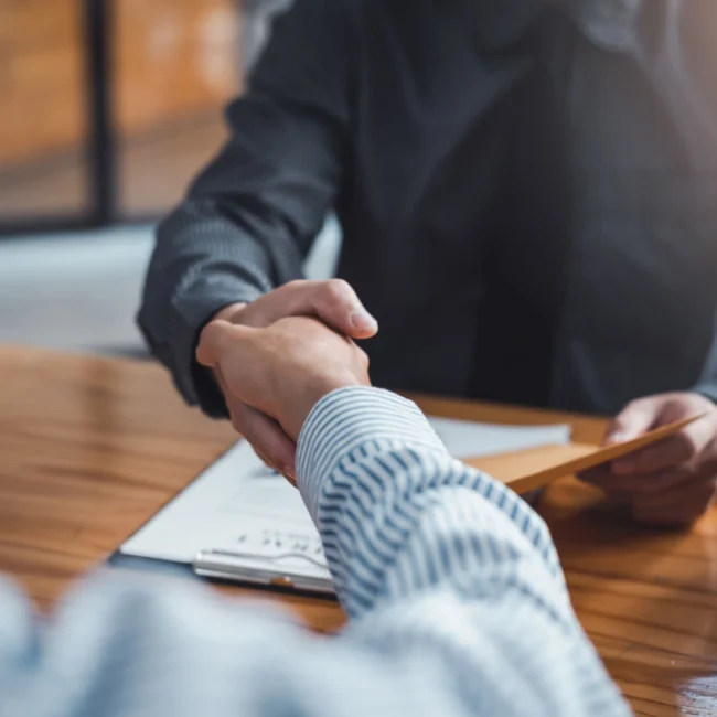 Legal malpractice lawyer shaking hands with his client