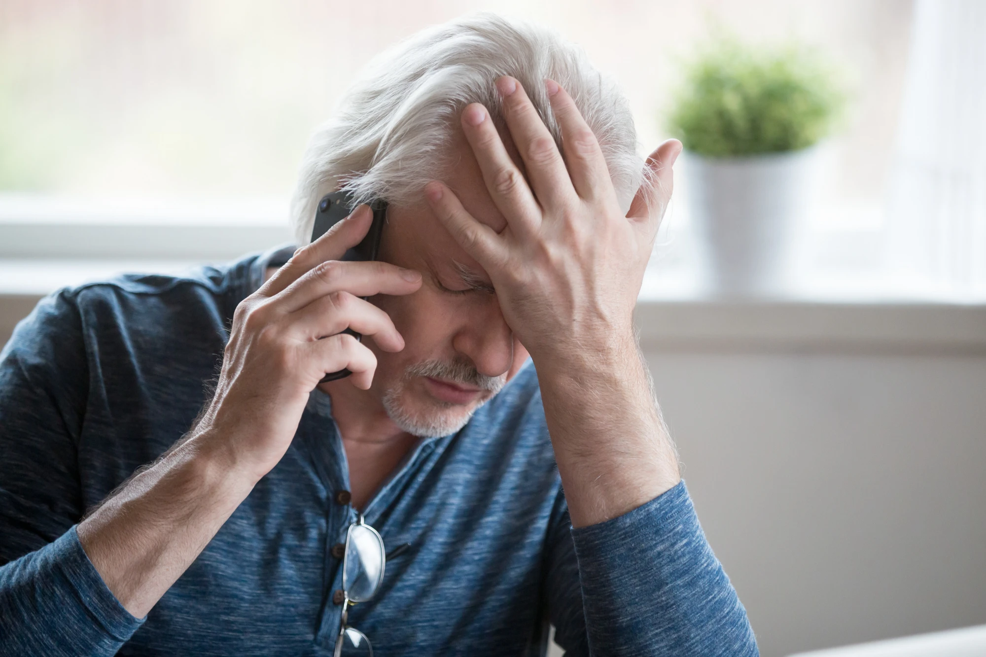 Frustrated man on the phone, unable to get in contact with his lawyer